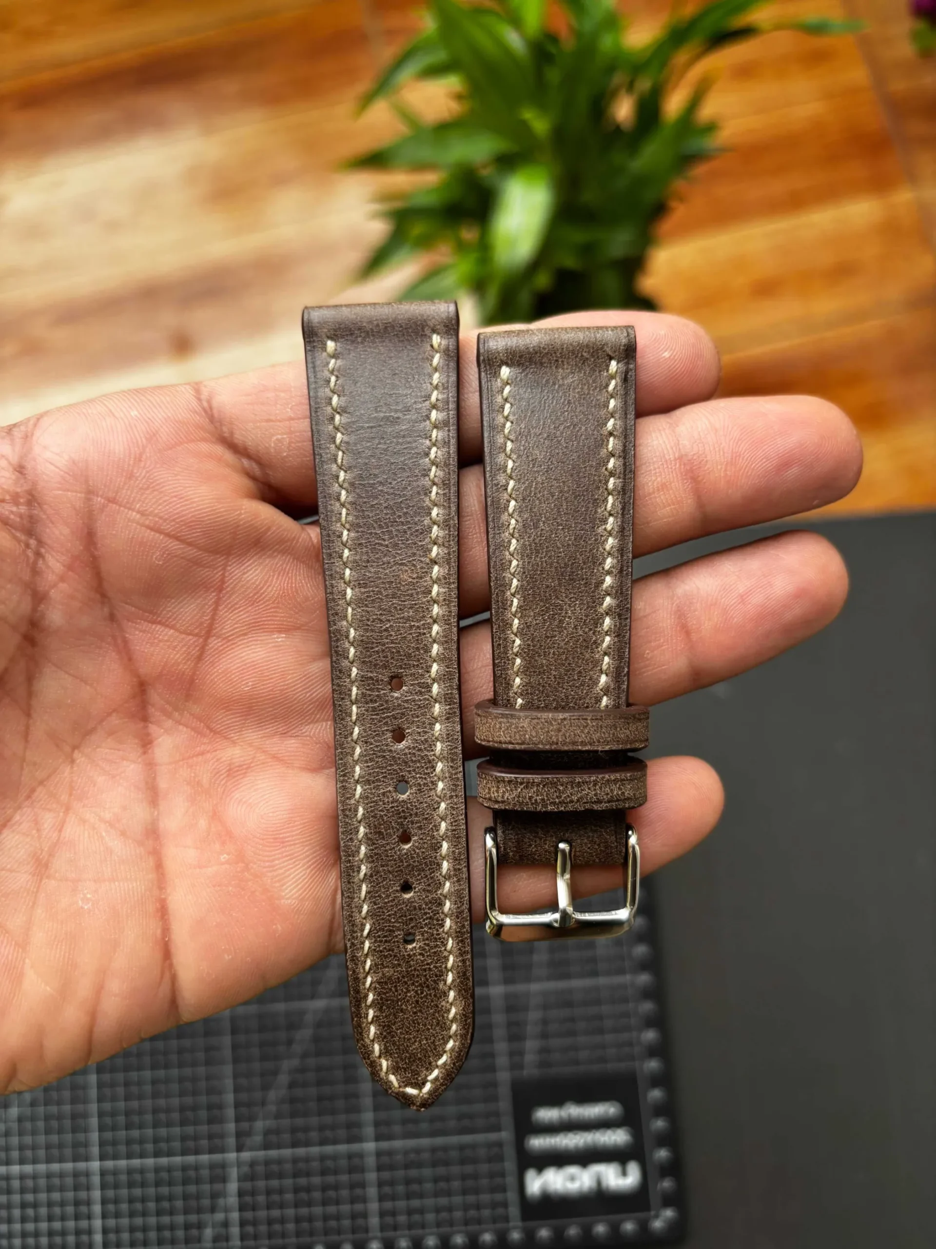 Aniline Vintage Distressed Brown Signature Cream Stitching Nakshara buckle worn on wrist